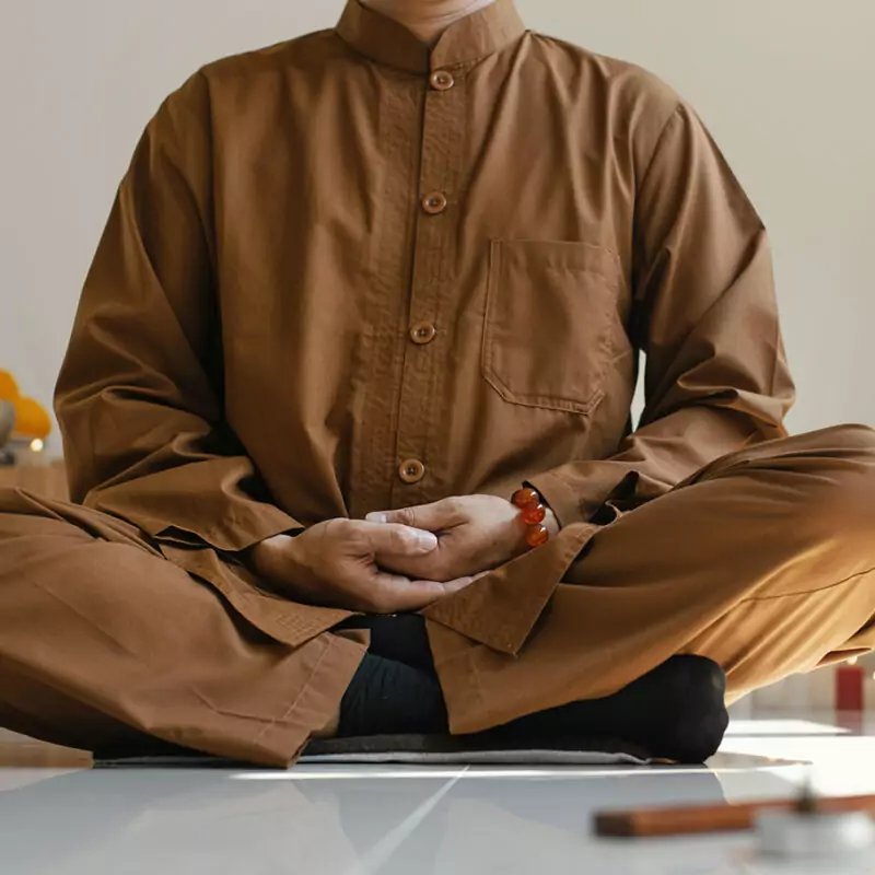 front view man meditating with incense resize